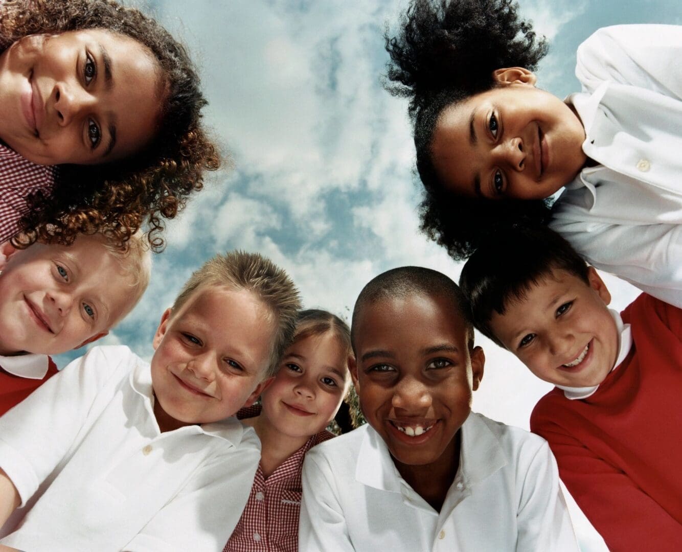 A group of children are smiling for the camera.