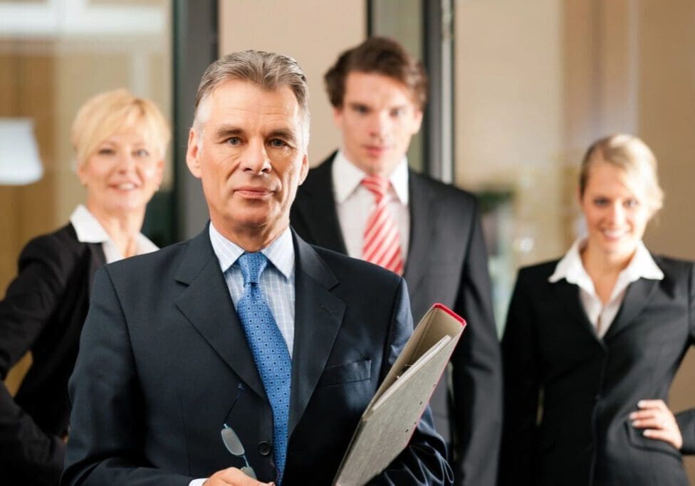 A group of people in suits and ties standing together.